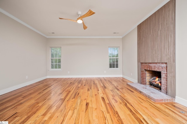 unfurnished living room featuring light wood-type flooring, ceiling fan, ornamental molding, and plenty of natural light