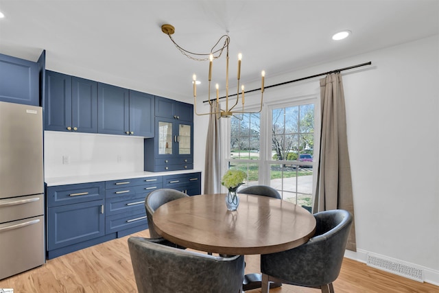dining area featuring a notable chandelier, light wood-type flooring, baseboards, recessed lighting, and visible vents