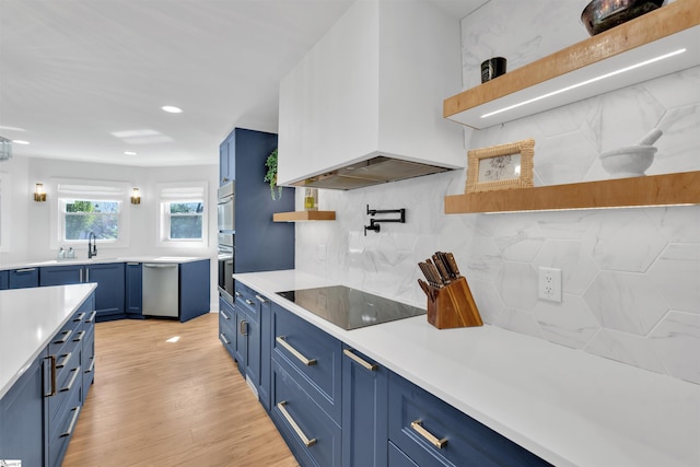 kitchen featuring blue cabinetry, open shelves, and appliances with stainless steel finishes