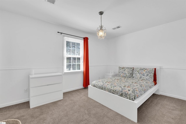 carpeted bedroom with baseboards and visible vents