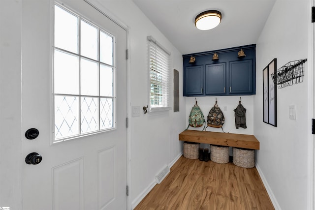 mudroom featuring wood finished floors, baseboards, and visible vents