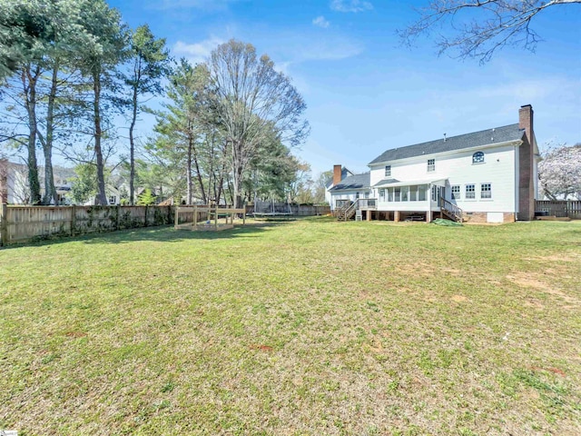 view of yard with a fenced backyard and a wooden deck
