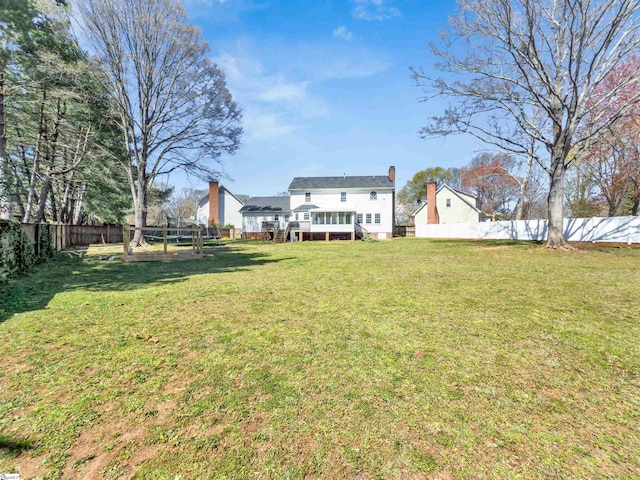 view of yard with a fenced backyard and a wooden deck