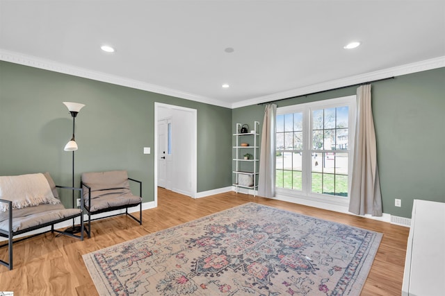 sitting room featuring recessed lighting, baseboards, ornamental molding, and wood finished floors