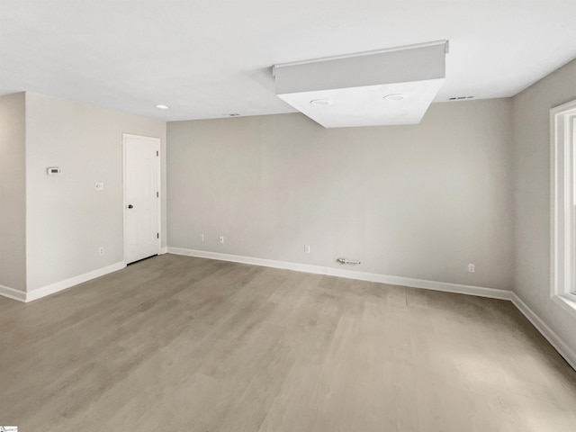 unfurnished room with light wood-style floors and baseboards