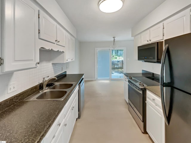 kitchen featuring tasteful backsplash, dark countertops, a sink, and stainless steel appliances