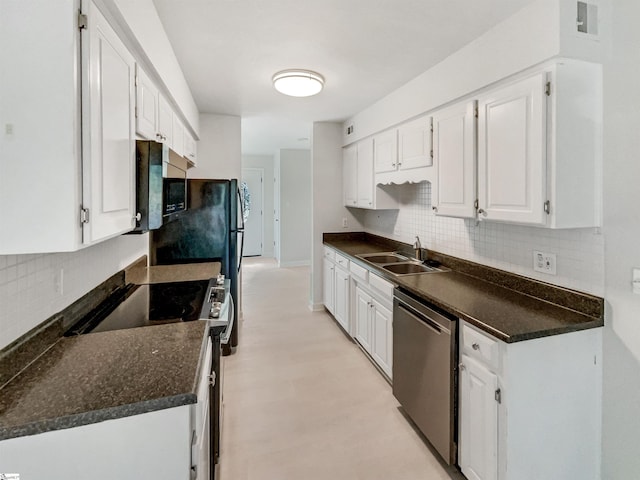 kitchen featuring stainless steel appliances, white cabinetry, and dark countertops