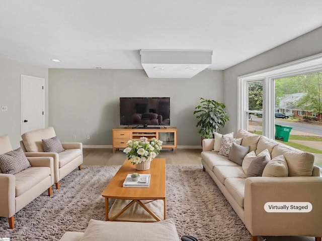 living room with light wood finished floors and baseboards