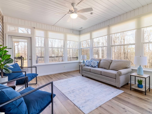sunroom with wood finished floors, an outdoor hangout area, ceiling fan, and a wooden deck