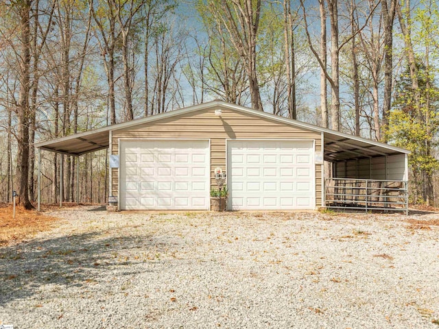 garage featuring driveway and a detached garage