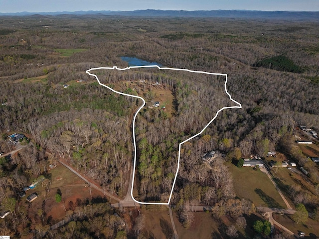 birds eye view of property with a view of trees