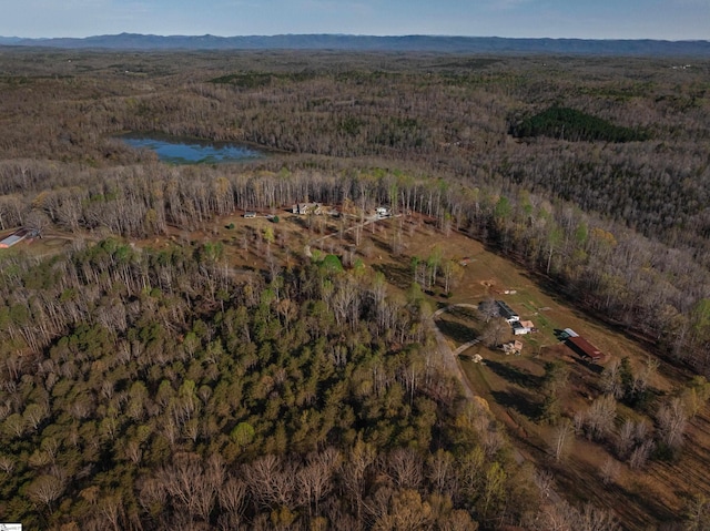 aerial view with a water view and a forest view