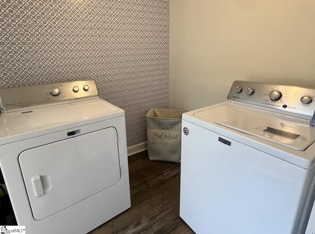 washroom with baseboards, washing machine and dryer, laundry area, and dark wood-style floors