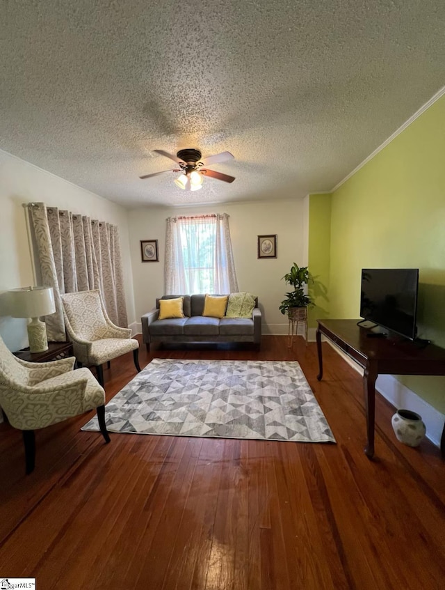 living room with crown molding, wood-type flooring, a ceiling fan, and a textured ceiling
