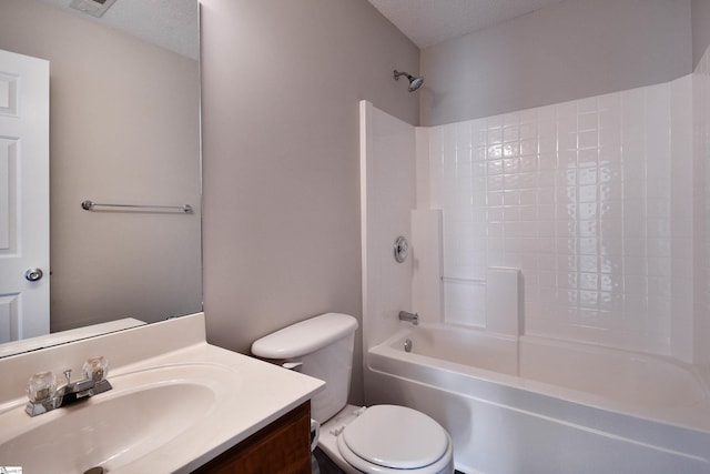 bathroom with shower / bath combination, vanity, a textured ceiling, and toilet