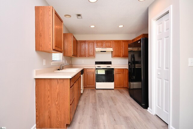 kitchen with visible vents, black refrigerator with ice dispenser, a sink, electric stove, and under cabinet range hood