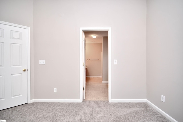 unfurnished bedroom with baseboards and carpet