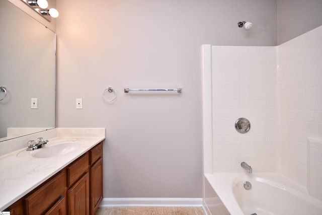 bathroom with baseboards, vanity, and bathing tub / shower combination