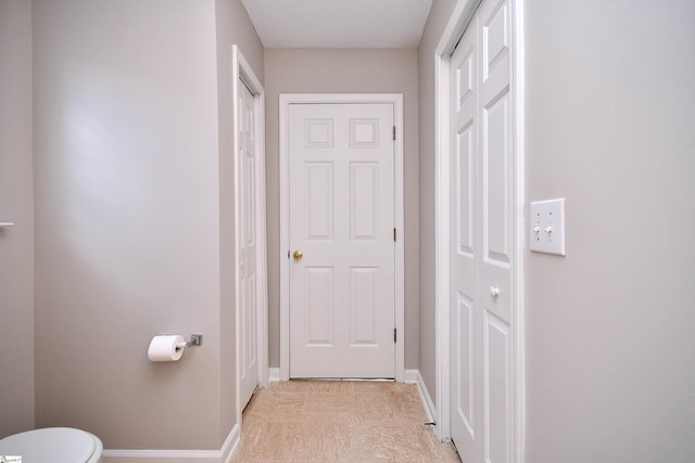 hallway featuring baseboards