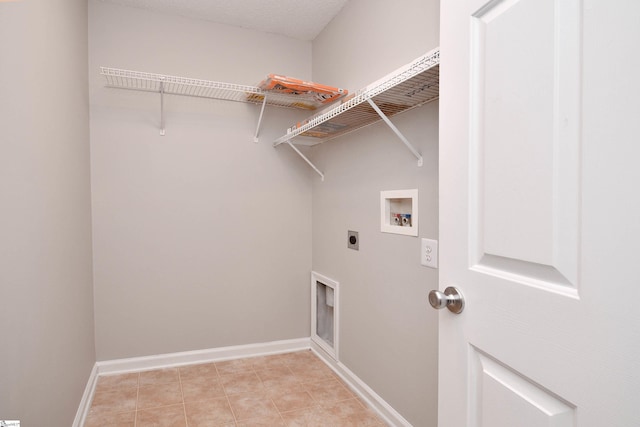 clothes washing area with light tile patterned floors, baseboards, washer hookup, laundry area, and electric dryer hookup