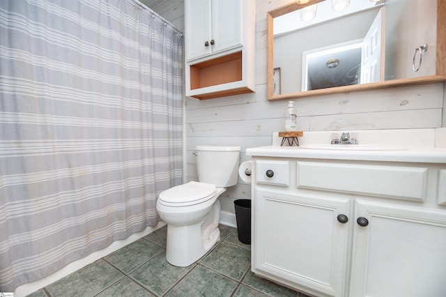 full bathroom with toilet, vanity, and tile patterned flooring