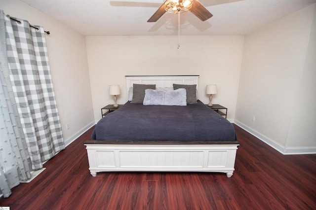 unfurnished bedroom with baseboards, a ceiling fan, and wood finished floors