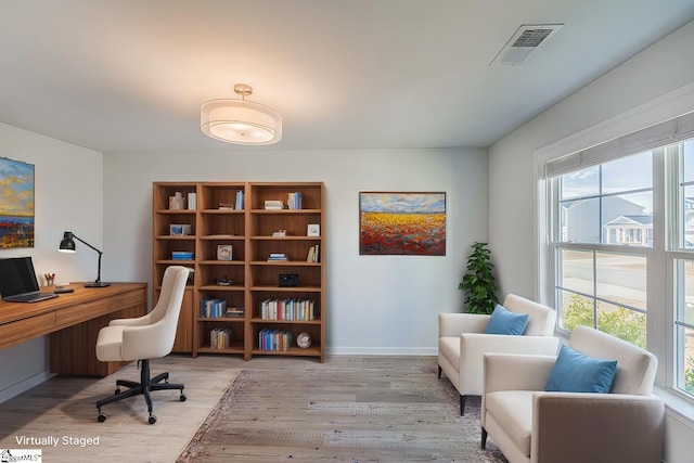 office area featuring visible vents, baseboards, and light wood-style floors
