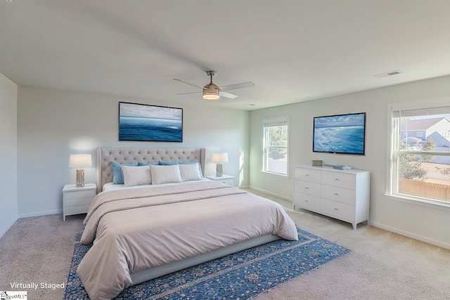 bedroom featuring visible vents, ceiling fan, light colored carpet, and baseboards