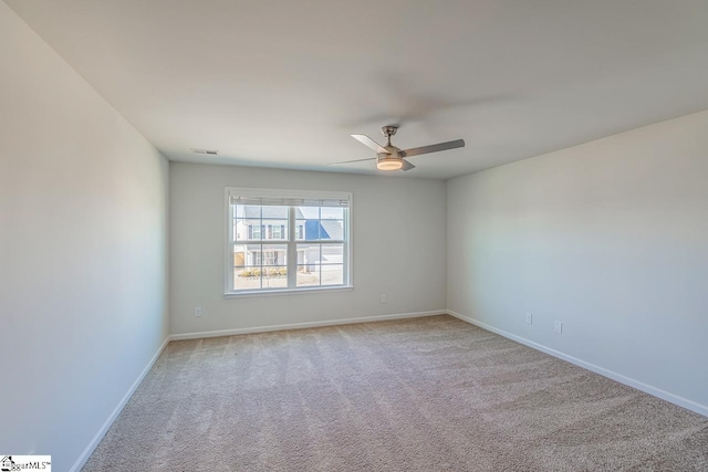 spare room featuring visible vents, ceiling fan, baseboards, and carpet