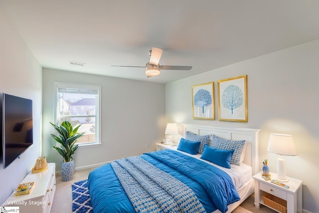 carpeted bedroom featuring visible vents, baseboards, and a ceiling fan
