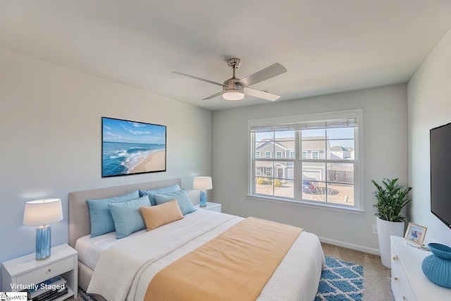 bedroom with light carpet, baseboards, and a ceiling fan
