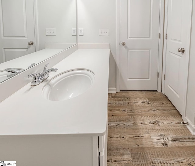 bathroom with vanity and wood finished floors
