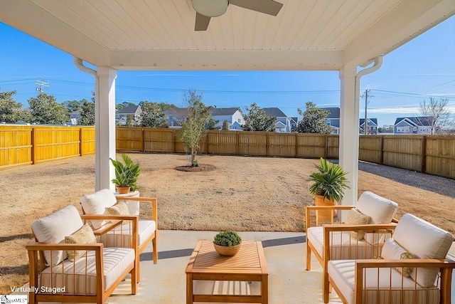 view of patio / terrace with an outdoor living space, a fenced backyard, and a ceiling fan