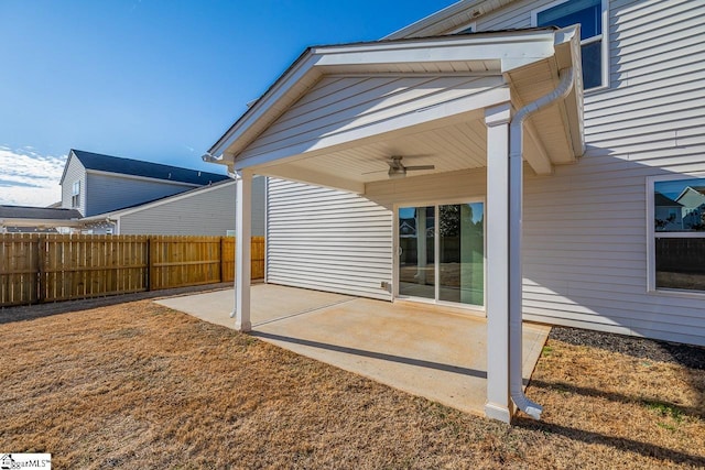 rear view of property with a patio, ceiling fan, and fence