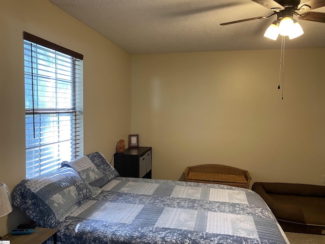 bedroom featuring a textured ceiling and ceiling fan
