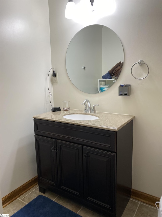 bathroom with vanity, tile patterned flooring, and baseboards