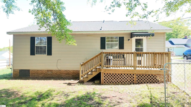 back of house featuring fence and a deck
