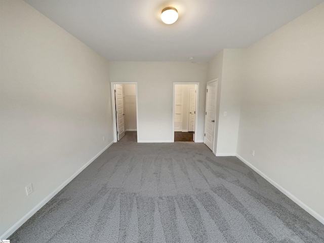 106 Elmhaven Dr, Simpsonville, SC 29681 - unfurnished bedroom with a spacious closet, baseboards, dark colored carpet, and connected bathroom