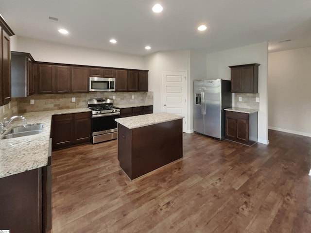 106 Elmhaven Dr, Simpsonville, SC 29681 - kitchen featuring dark brown cabinetry, a kitchen island, appliances with stainless steel finishes, a sink, and dark wood-style floors