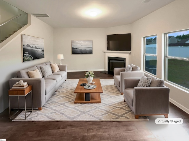 106 Elmhaven Dr, Simpsonville, SC 29681 - living area with baseboards, a glass covered fireplace, visible vents, and stairs