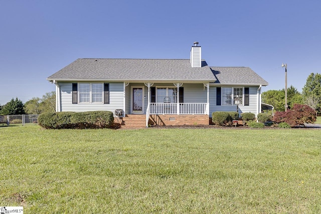 ranch-style house with a porch, a chimney, fence, a front lawn, and roof with shingles