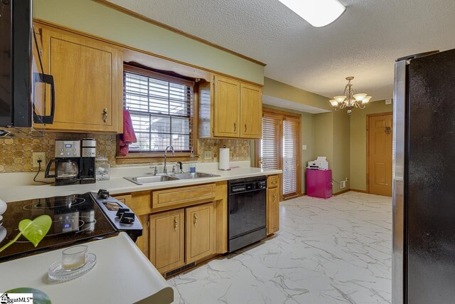kitchen with a notable chandelier, black dishwasher, a sink, freestanding refrigerator, and marble finish floor