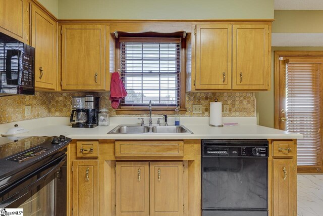 kitchen featuring light countertops, marble finish floor, a sink, and black appliances