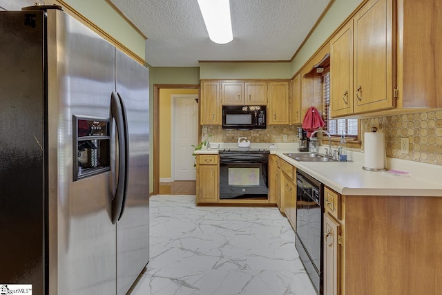 kitchen with black appliances, marble finish floor, light countertops, a sink, and decorative backsplash