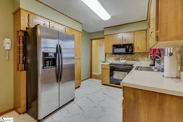 kitchen with a sink, light countertops, black appliances, decorative backsplash, and marble finish floor