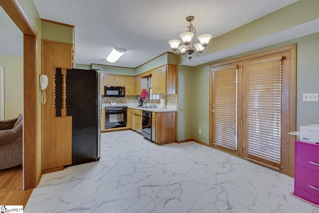 kitchen with a notable chandelier, light countertops, black appliances, marble finish floor, and a sink