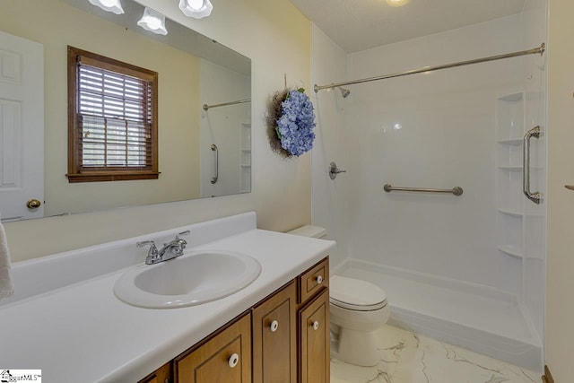 bathroom featuring toilet, a shower, marble finish floor, and vanity