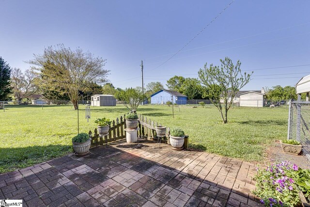 view of patio / terrace with a storage shed, a fenced backyard, and an outdoor structure