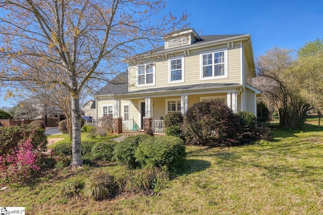 traditional style home with a porch and a front yard