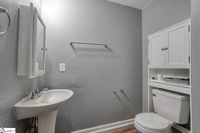 half bathroom featuring toilet and wood finished floors